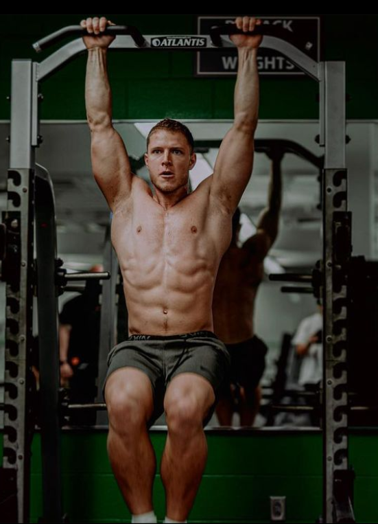 Christian McCaffrey working out in a gym