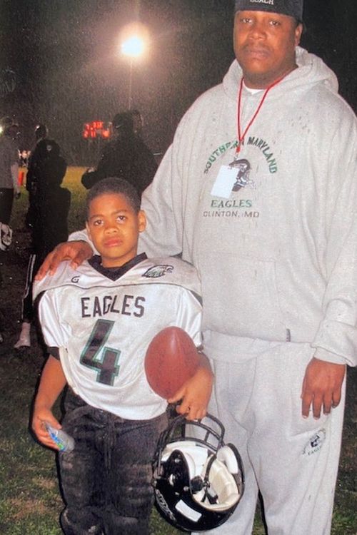 A Young Chase Young Pictured With His Father Greg Young At An Football Event