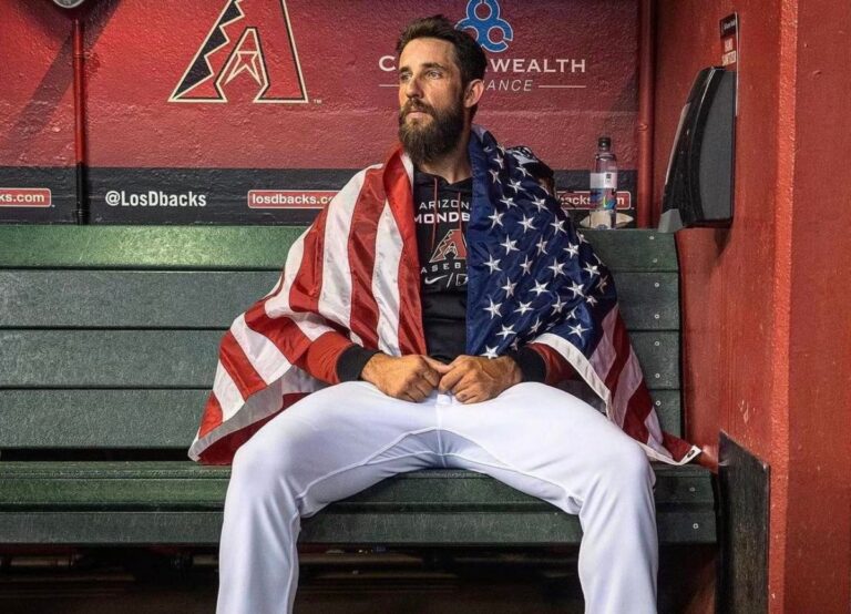 Madison Bumgarner Pictured In His Diamondback Gear With The US Flag Draped Over Him