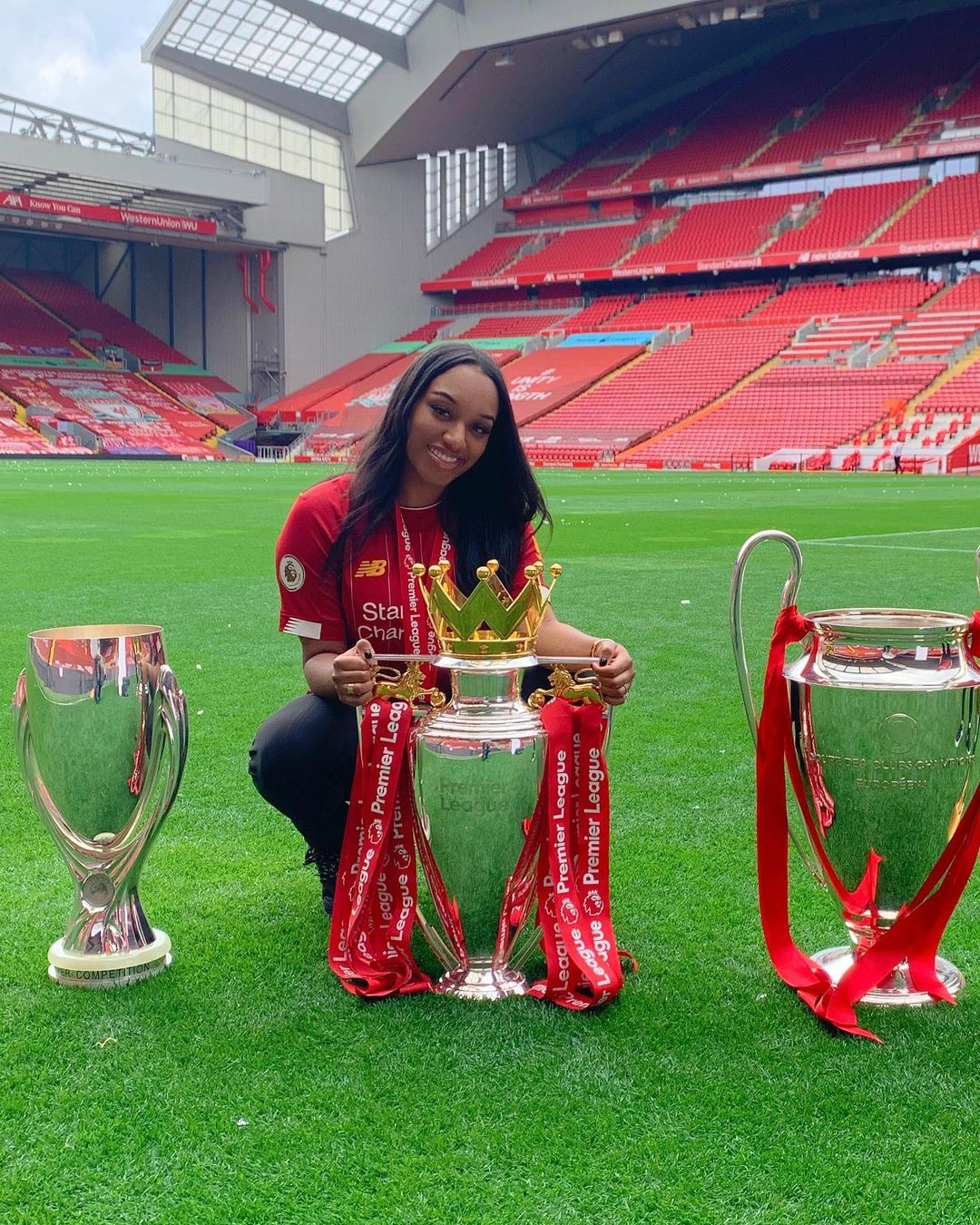 Tamara Tia Gomez Is Photographed In Anfield With Premier League, UCL, And Super Cup