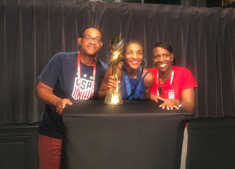Crystal Dunn With Her Parents, Vincent, And Rhonda Dunn Holding The 2019 World Cup Trophy