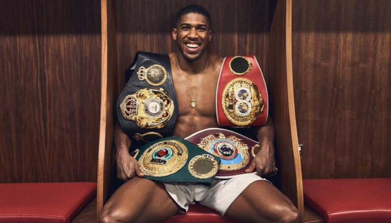 Anthony Joshua Showcasing His Belts