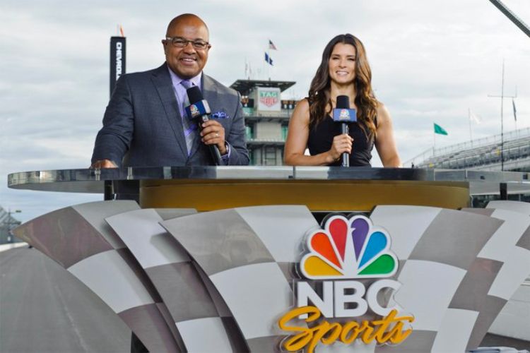 Mike Tirico With Co-Host Danica Patrick On Their Sportscasting Duties In NBC