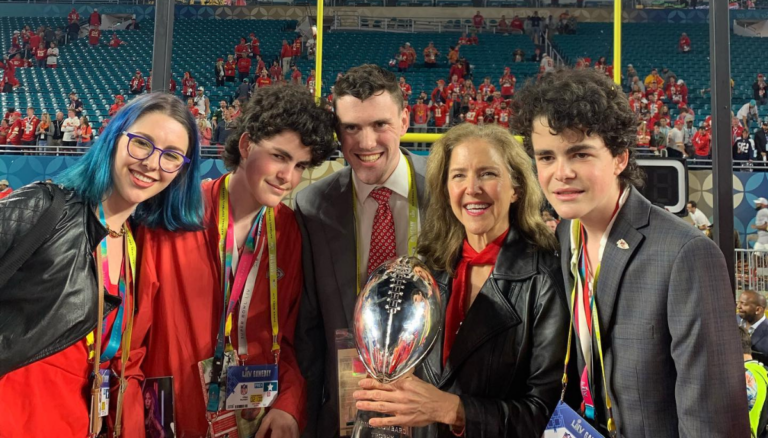 Sharron Hunt With Her Children Holding NFL Trophy