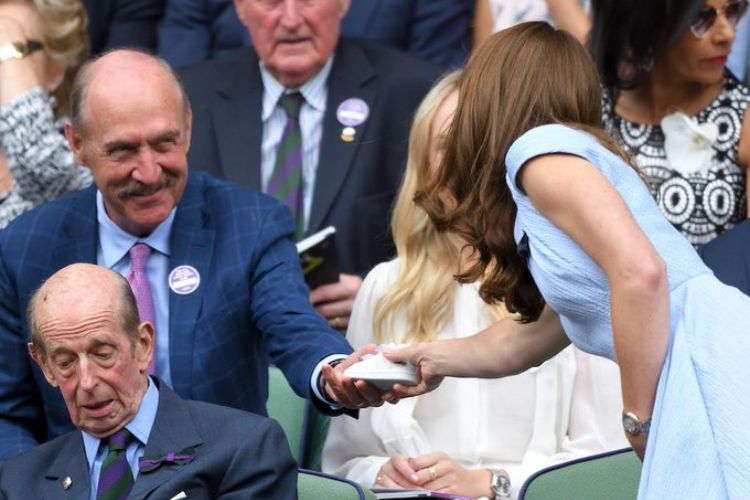 Stan Smith Hands Over The Stan Smith Shoe To The Duchess of Cambridge, Kate Middleton During Wimbledon Tournament In 2019
