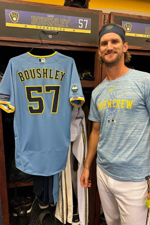 Caleb Boushley Poses In Front Of His Jersey At The Brewers Changing Room 