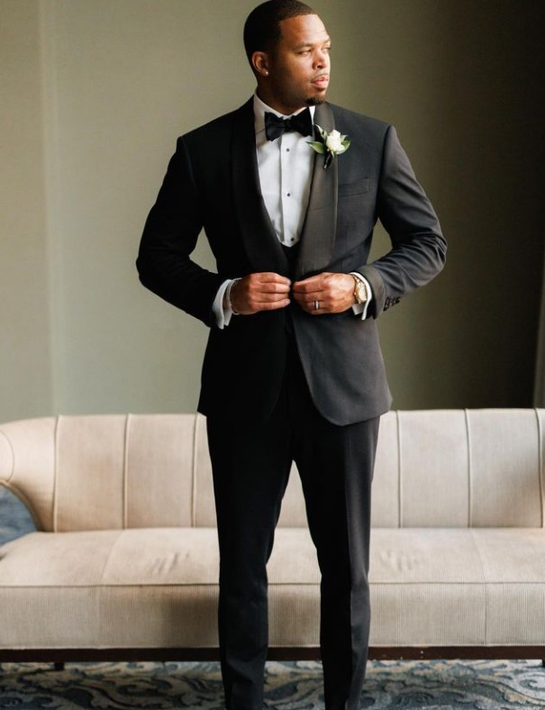 Marcus Cromartie poses for a photograph in a suit