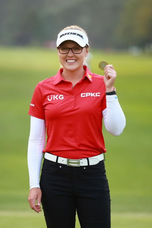 The Golfer Holding Her Winning Medal 