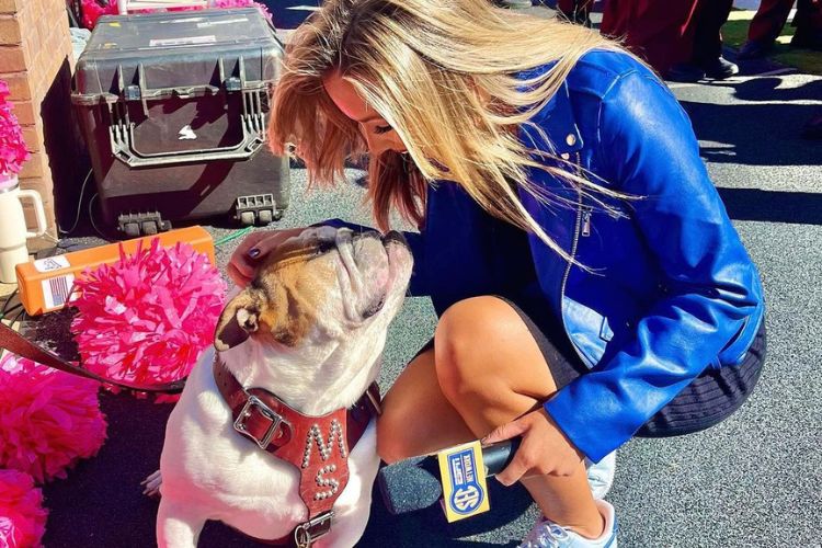 Taylor Looks Lovingly At A Pet Bulldog During Her Interview Session At Davis Wade Stadium