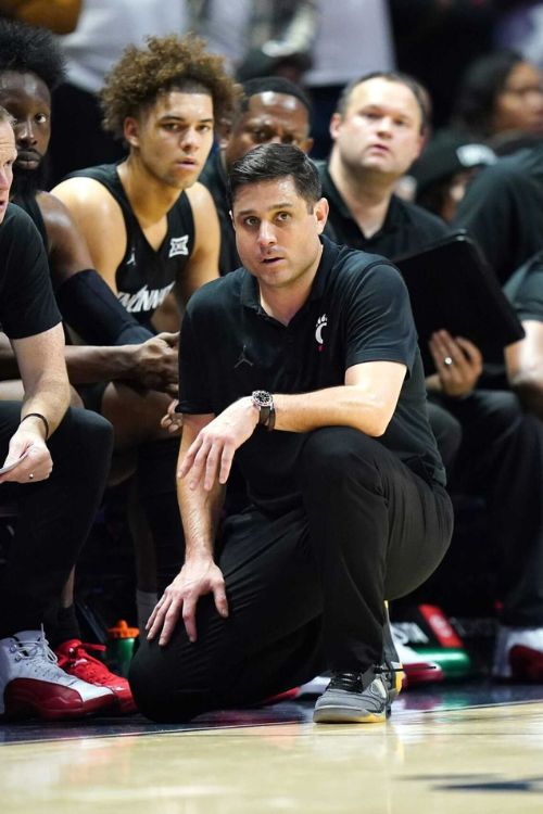 The University of Cincinnati Coach, Wes Miller, Pictured On The Sidelines Discussing With His Team 
