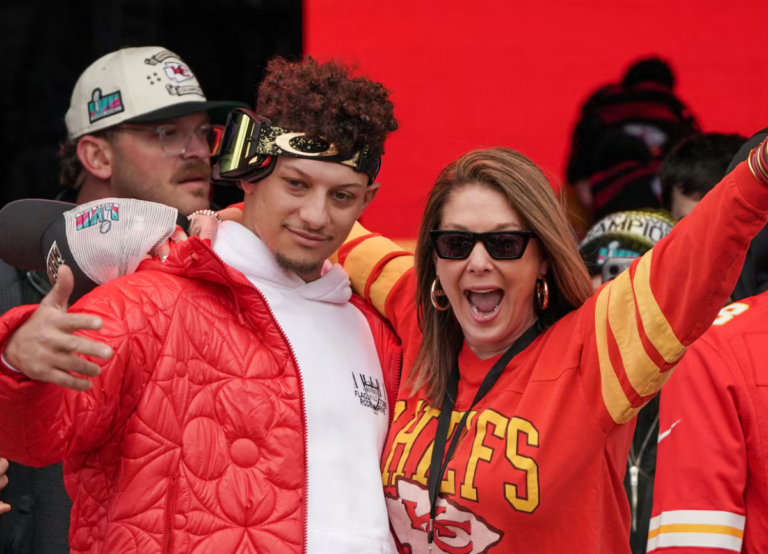 Patrick Mahomes of the Kansas City Chiefs and mother Randi Mahomes celebrate on stage during the Kansas City Chiefs Super Bowl LVII victory parade on February 15, 2023.