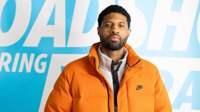 Paul George pictured in an orange-color jacket