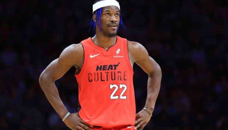 Jimmy Butler wearing his Miami Heat jersey and flexing his unique hairstyle