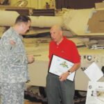 Col. Scott King speaks with U.S. Army Reserve Ambassador Ted Sarandis during his Fort Benning visit.
