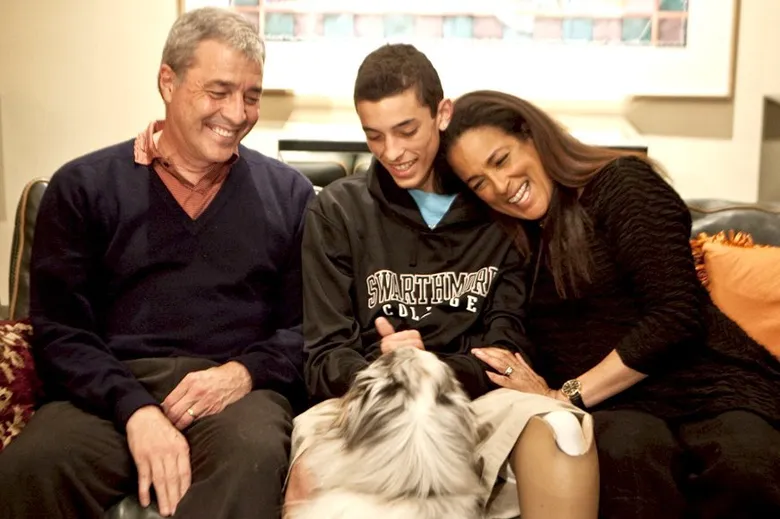 Cooper Woolston, along with his father V., mother Robyn, and the family dog.
