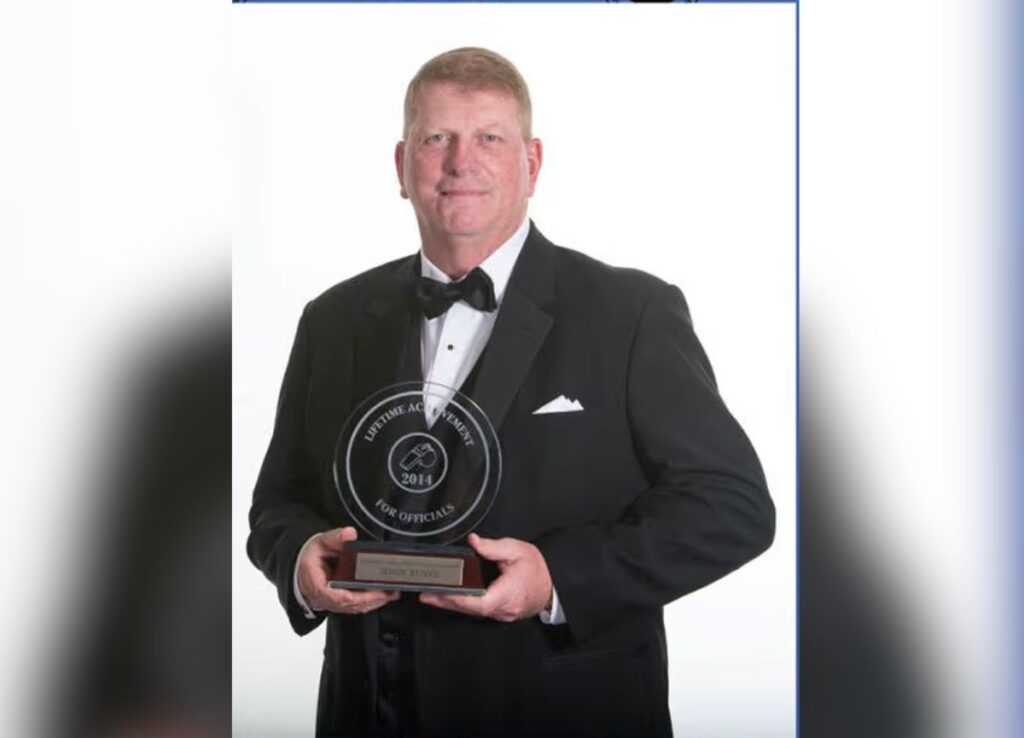 Coach Jerry Kuntz. holding Lifetime Achievement Award