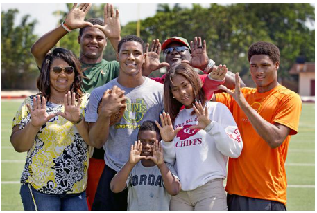 Kenny McIntoshm with ball, is pictured with his family 