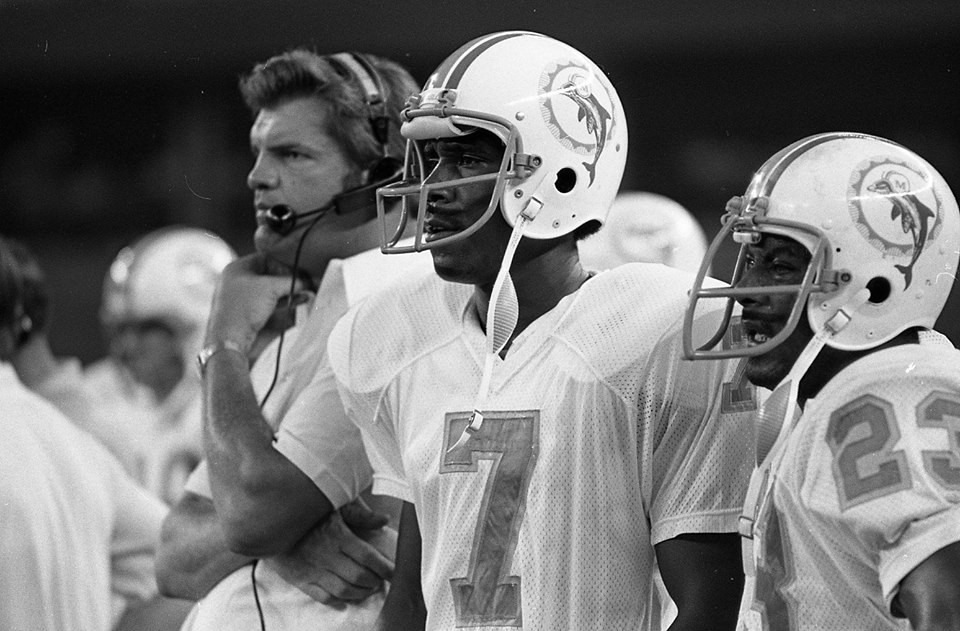 Miami Dolphins rookie quarterback Craig Curry on the sidelines with assistant coach Monte Clark and running back Charlie Leigh