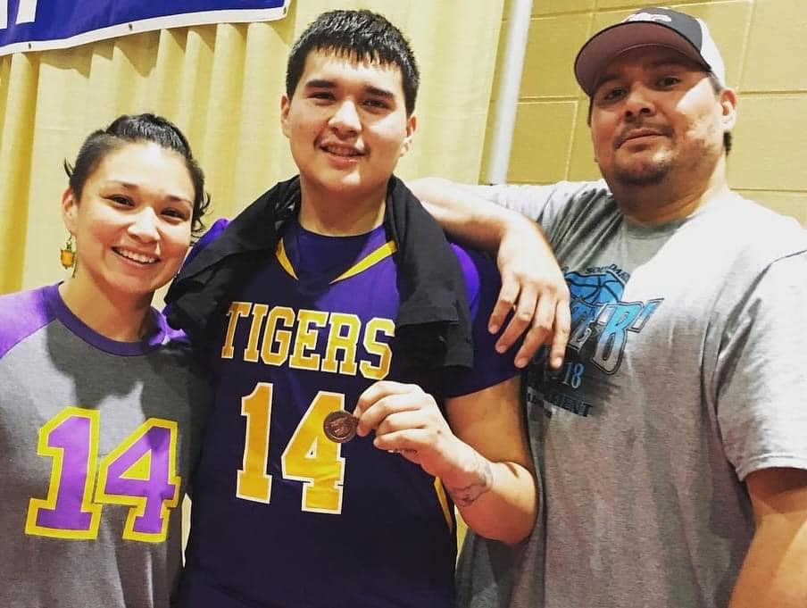 Teron Sazue with his parents